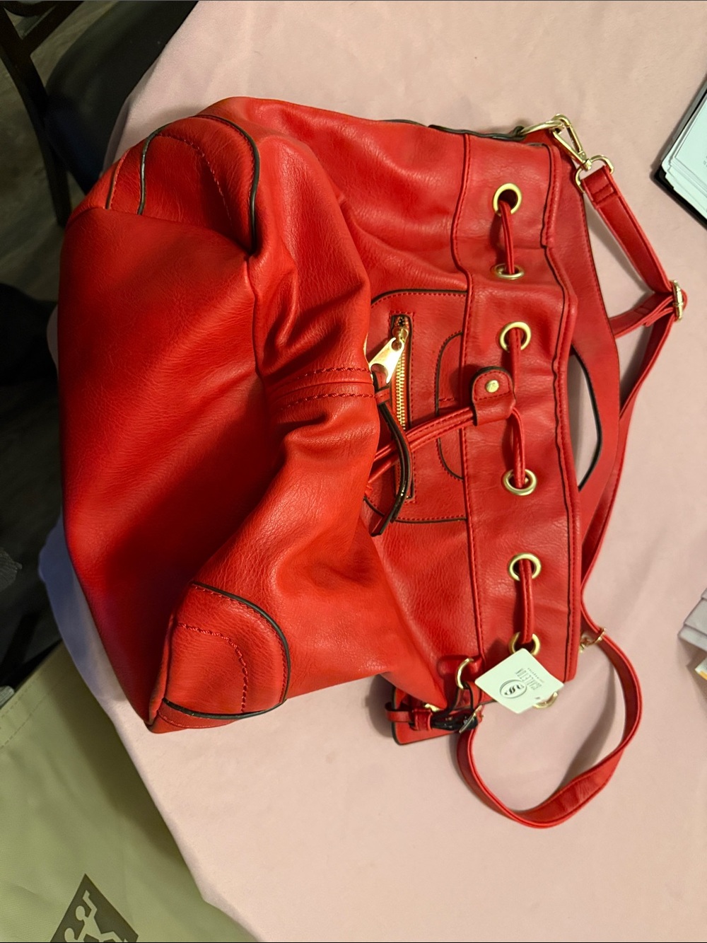 Stylish Red Leather Drawstring Hobo Bag with Gold Accents